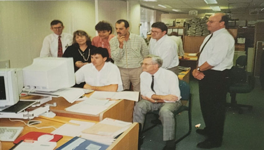 CSC Staff surrounding a computer