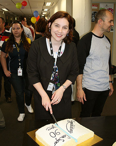 Jill Charker CEO cuts 90 year cake