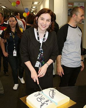Jill Charker CEO cuts 90 year cake
