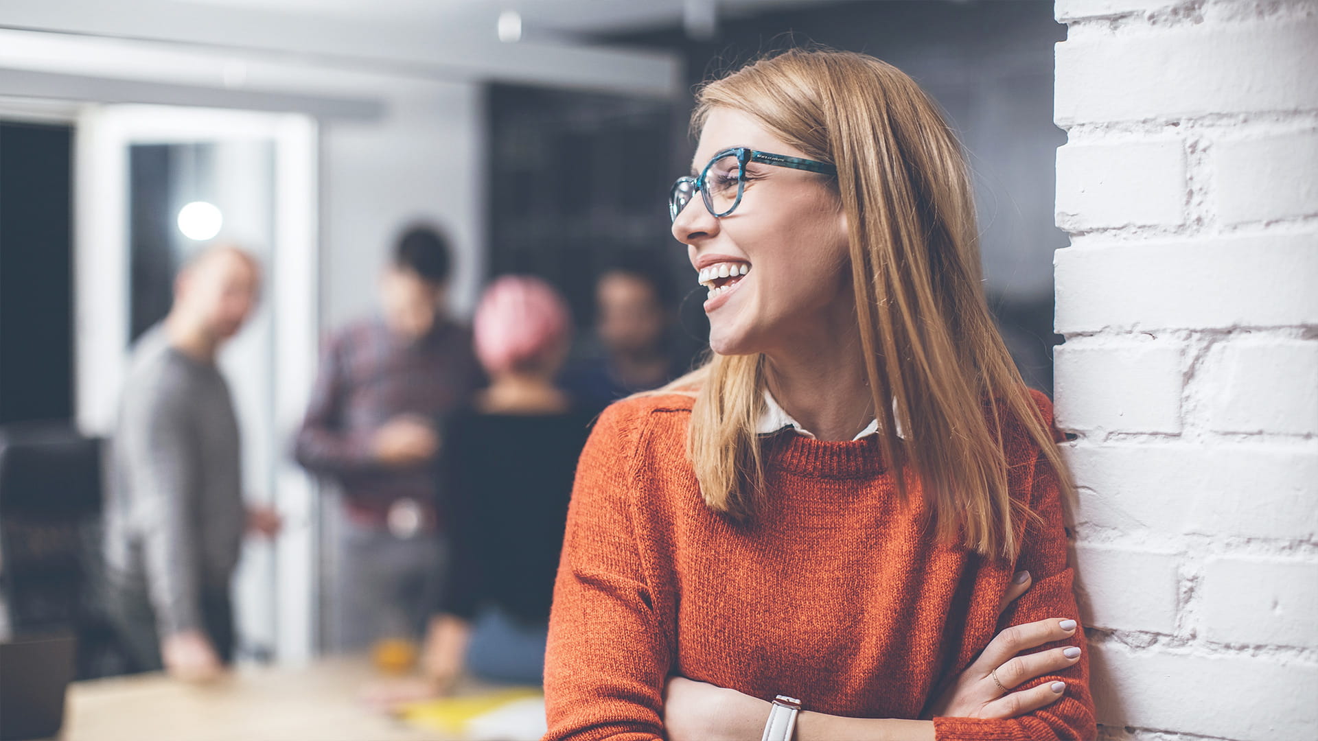 Young satisfied woman employee with glasses