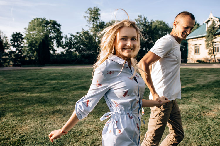 Couple walking across garden