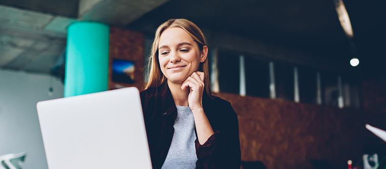 young woman looking at her computer
