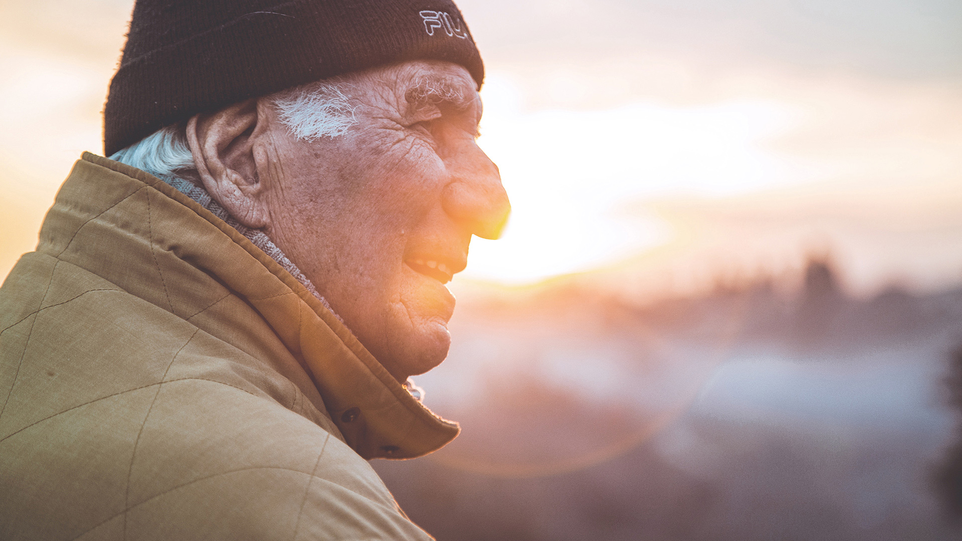 Super insured senior man wearing hat gazing in distance