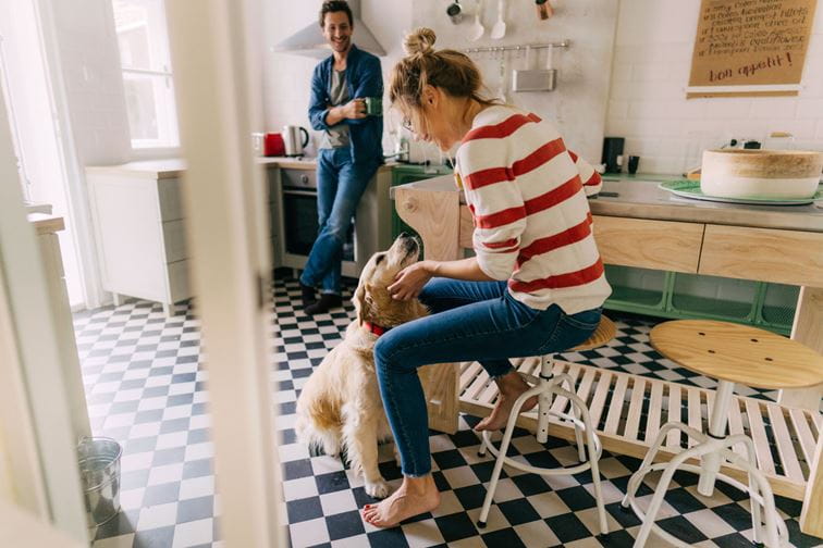 Couple in the kitchen with their dog