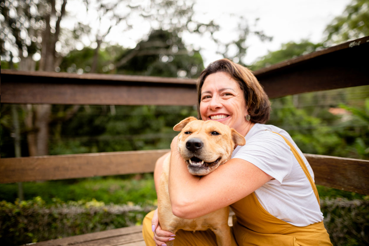 Middle aged woman cuddling her dog