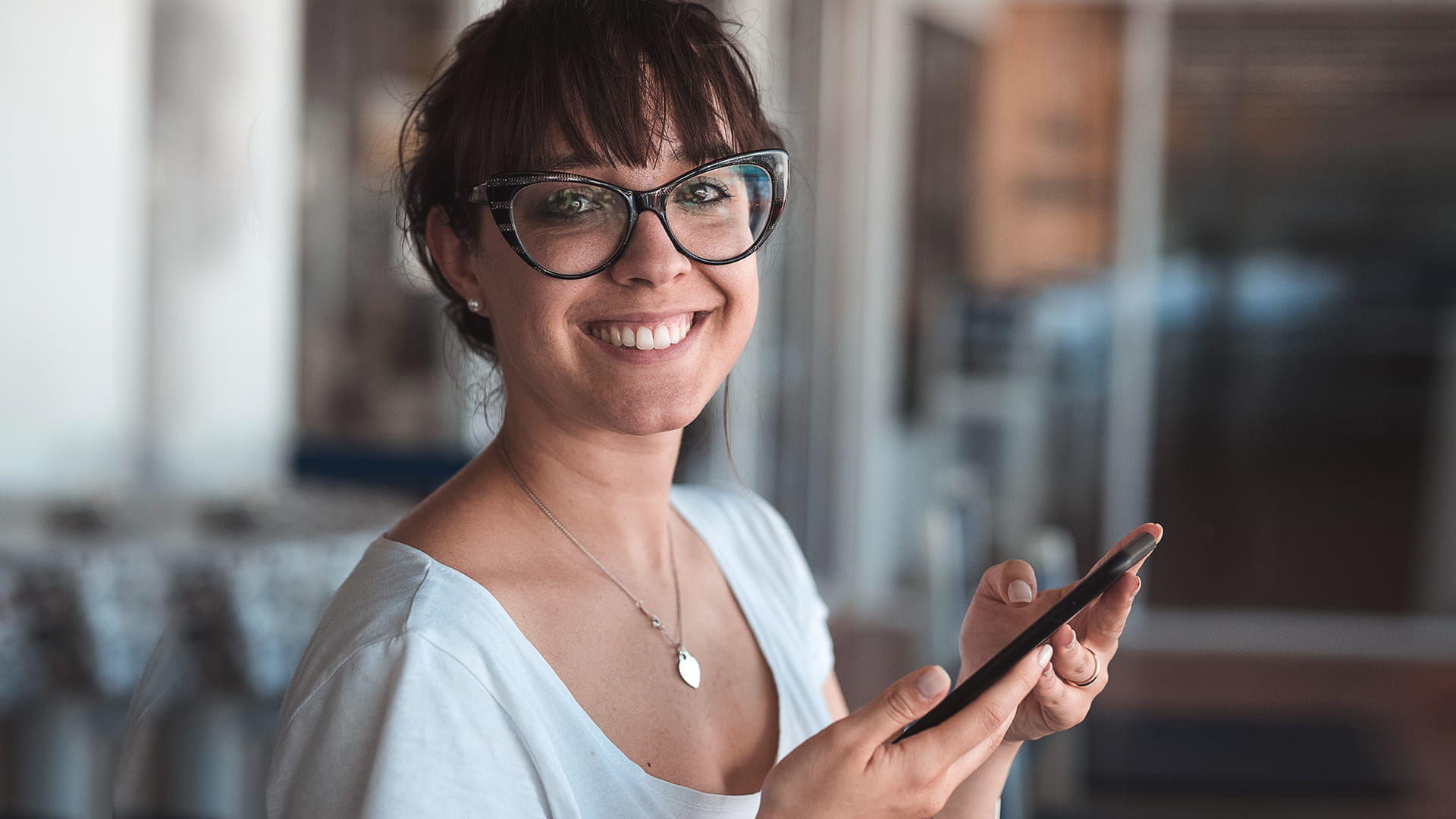 Woman with glasses smiling after using super calculator