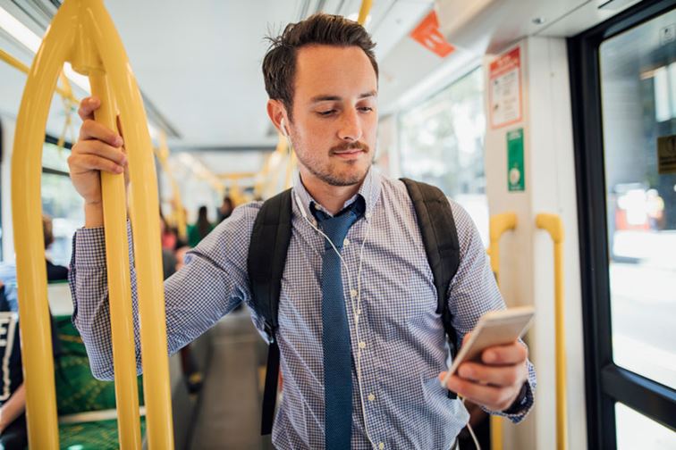 Man on a tram looking at this mobile