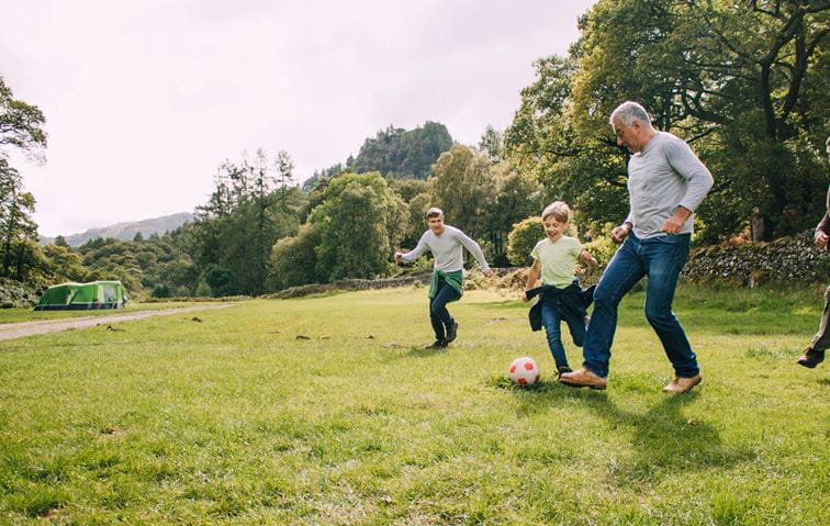 Family playing soccer