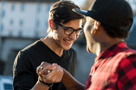 Two young men shaking hands