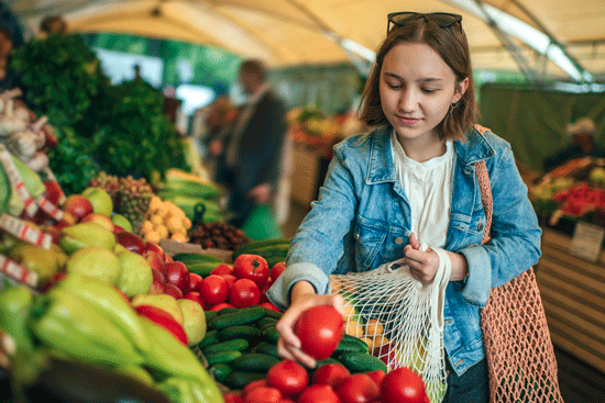 Young woman shopping at vegetable market