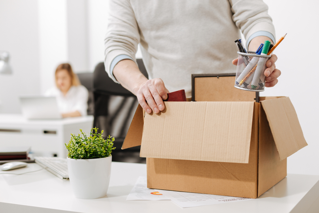 Man packing up his work desk