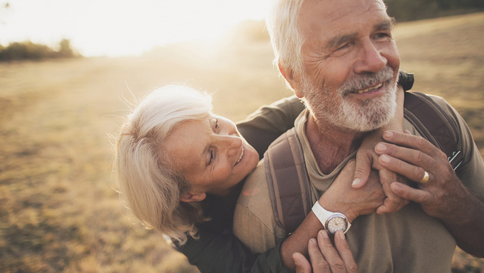 Couple on field holding each other
