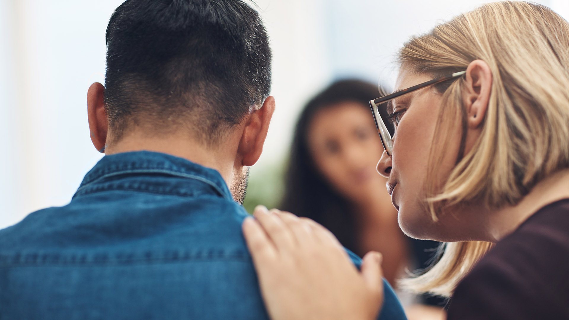 a woman comforts a man