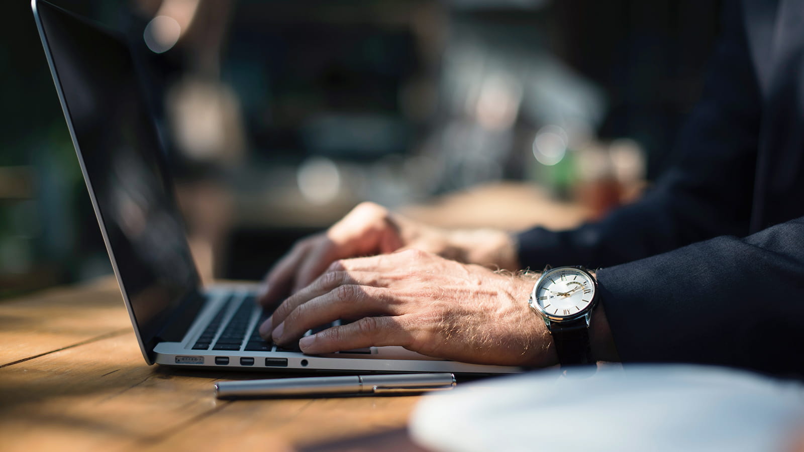 Image of person typing on a laptop computer