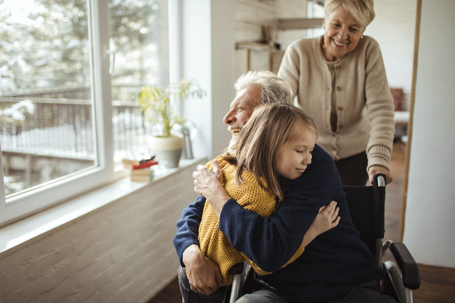 Photo of granddad hugging granddaughter
