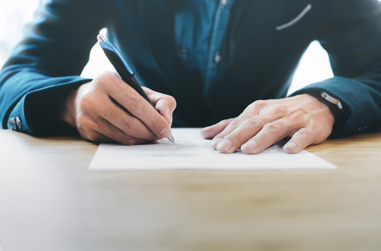 Man writing on a piece of paper