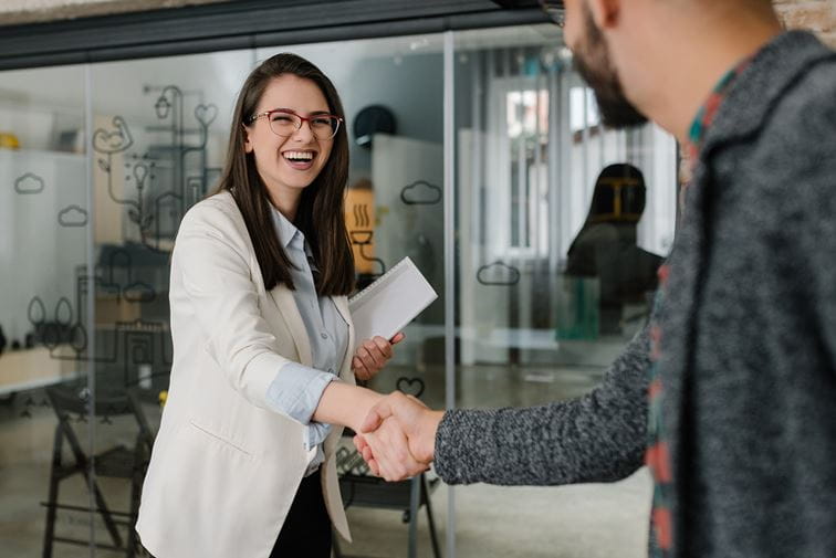 Woman starting new job, shaking hands